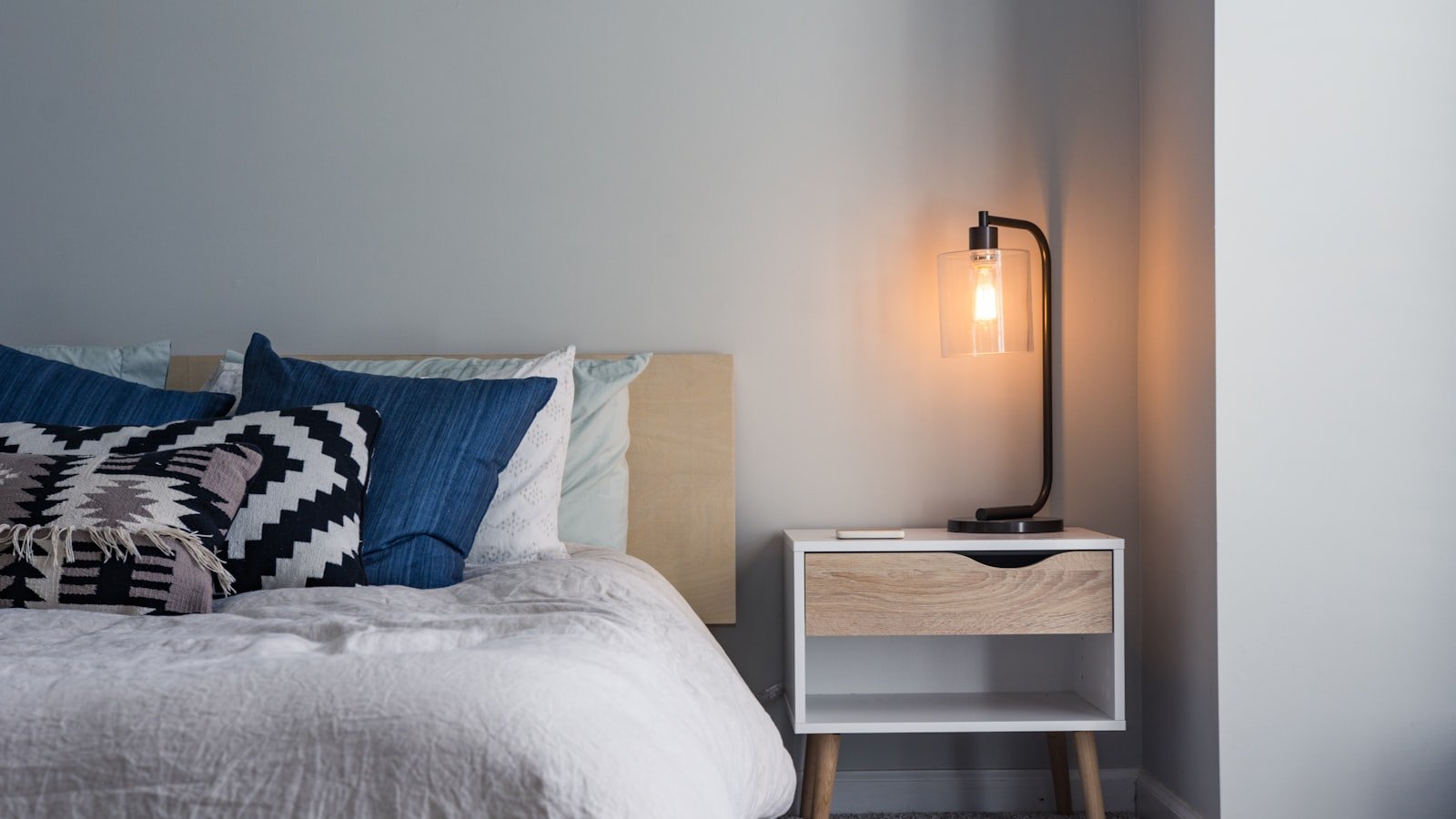 Crisp white bedding on a neatly made bed in a calm bedroom